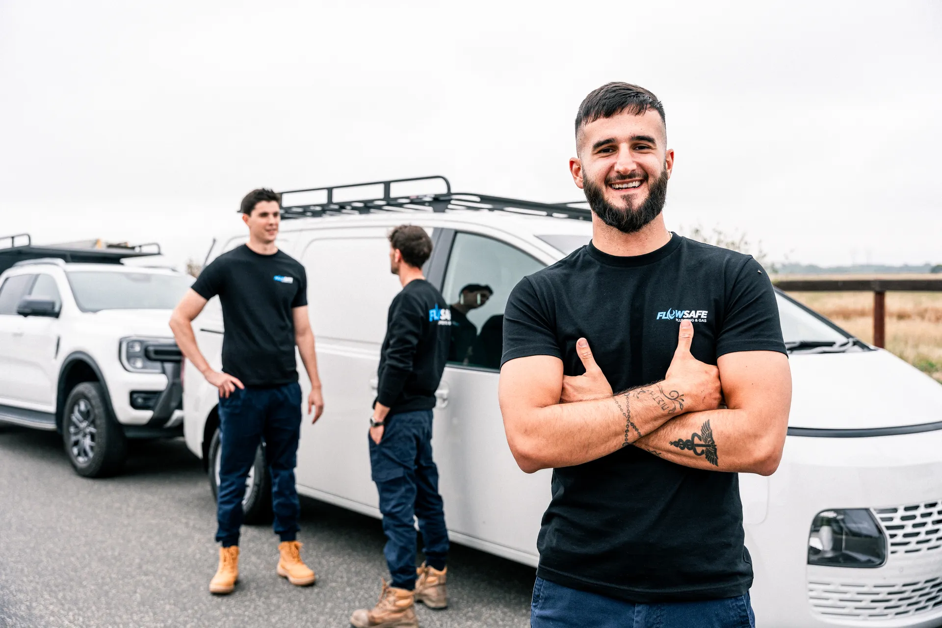 Mr Drainage team beside their service vehicles in Melbourne